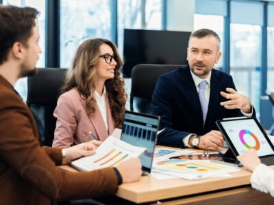 Business meeting in an office, workers discussing business affairs. Gadgets and papers on the table